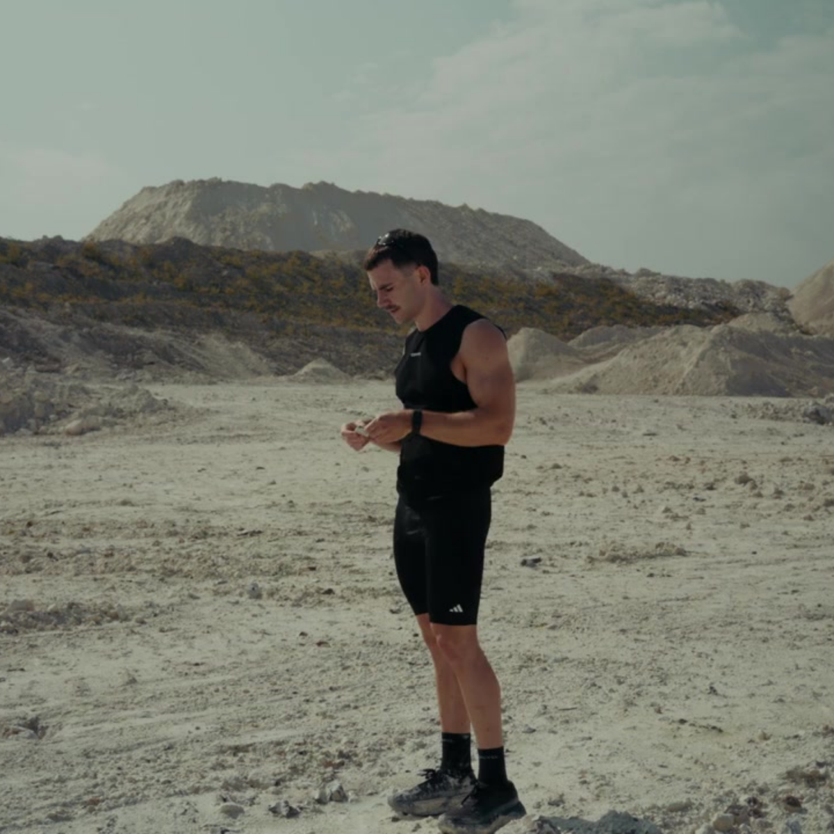 Athlete tearing open two Supplme pouches with their teeth